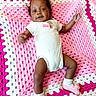 baby, infant, child, onesie, sock, blanket, crochet, pink, white, smile, cute, lying_down, portrait, indoor, soft_texture, happy, young_child, toddler, footwear, person
