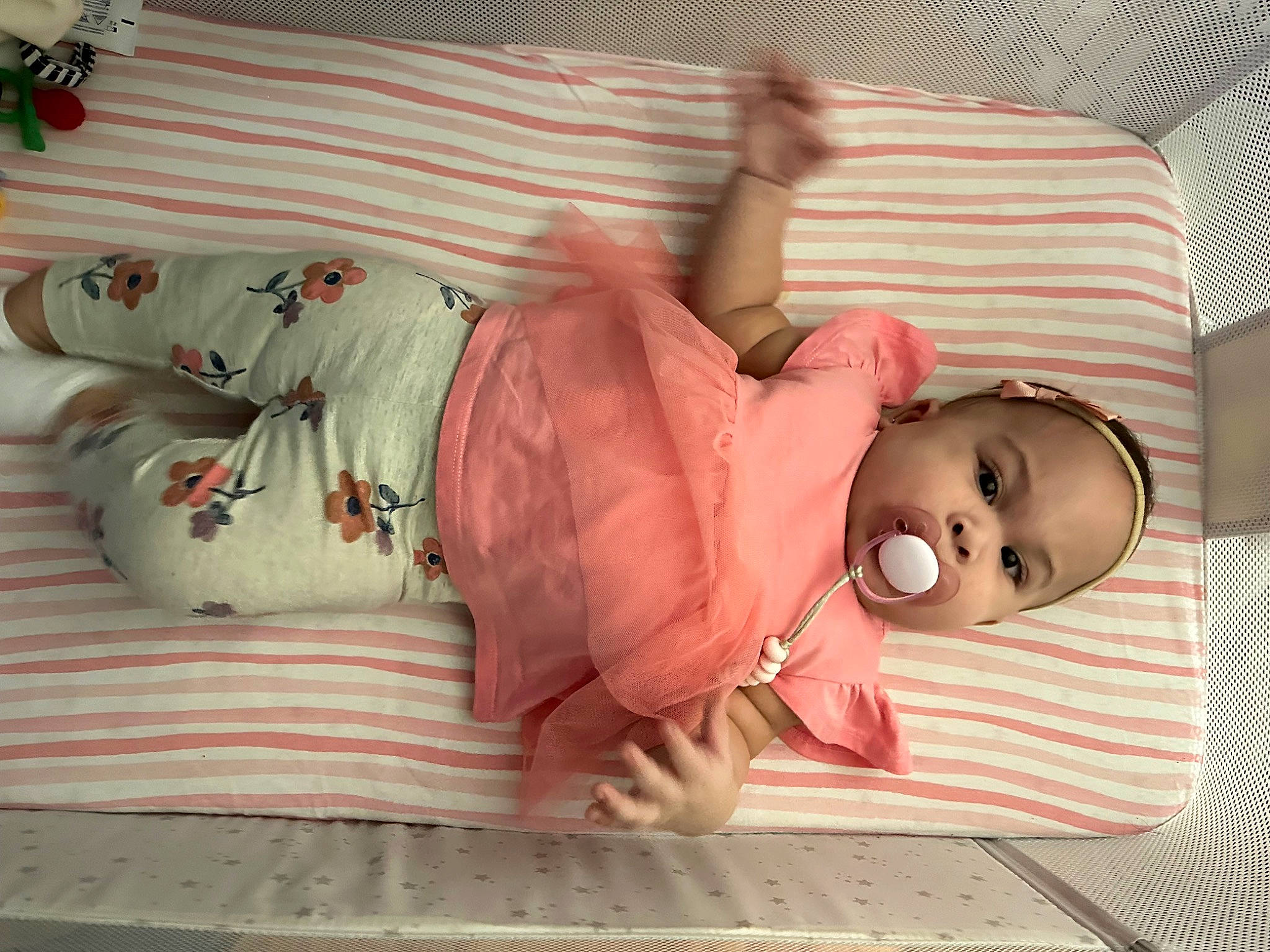 Charlotte is registered to the contest to win money with this photo: arm, baby, baby_products, baby_sleeping, baby_toddler_clothing, bed, bedding, bedtime, child, clothing, comfort, flooring, human_body, linens, mammal, person, pink, room, sleeve, toddler