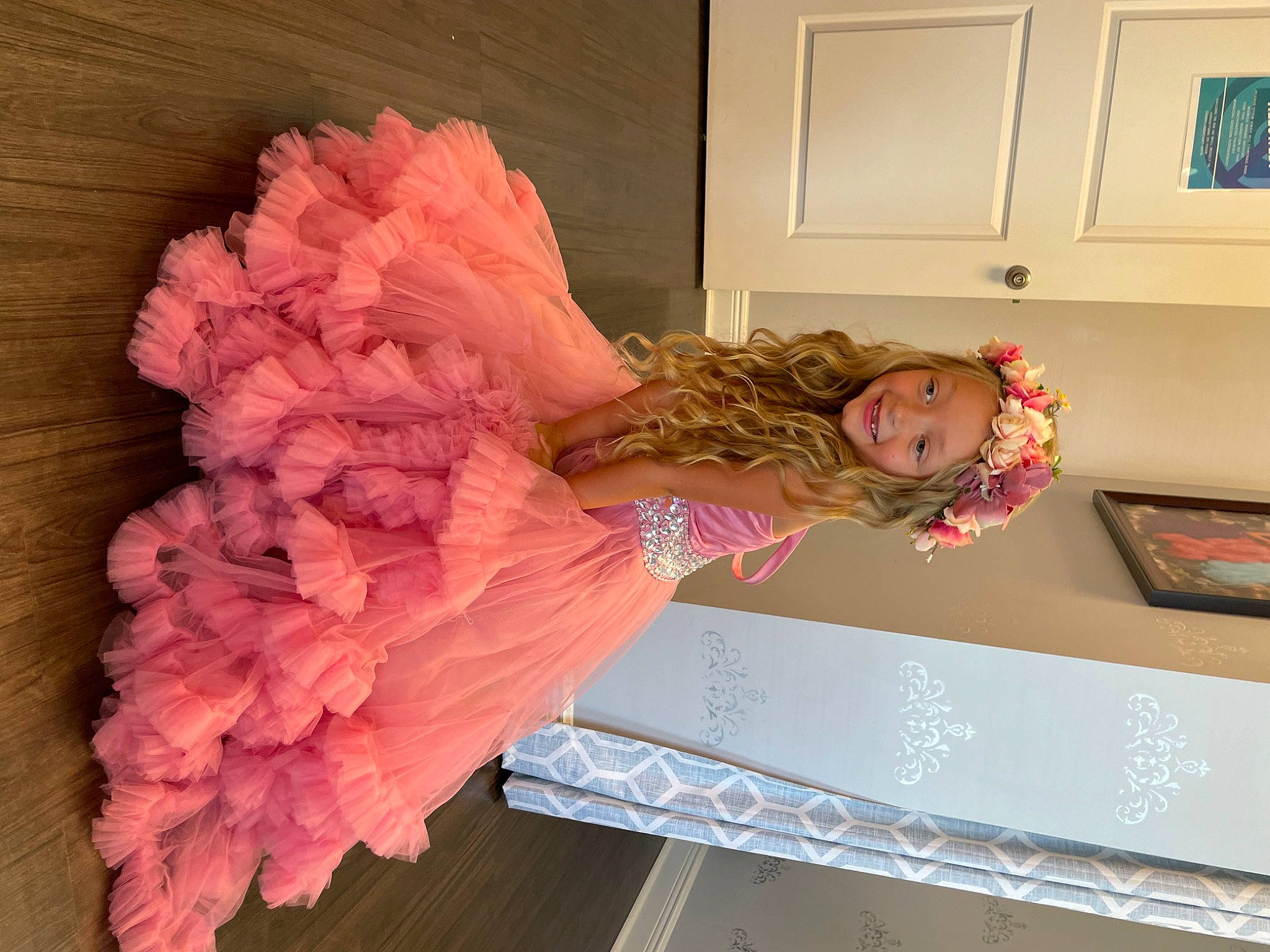 Kinsley is registered to the contest to win money with this photo: arm, baby_toddler_clothing, child, clothing, costume, cut_flowers, drawer, fashion_design, fun, headpiece, joy, magenta, peach, person, petal, picture_frame, pink, plaster, room, ruffle