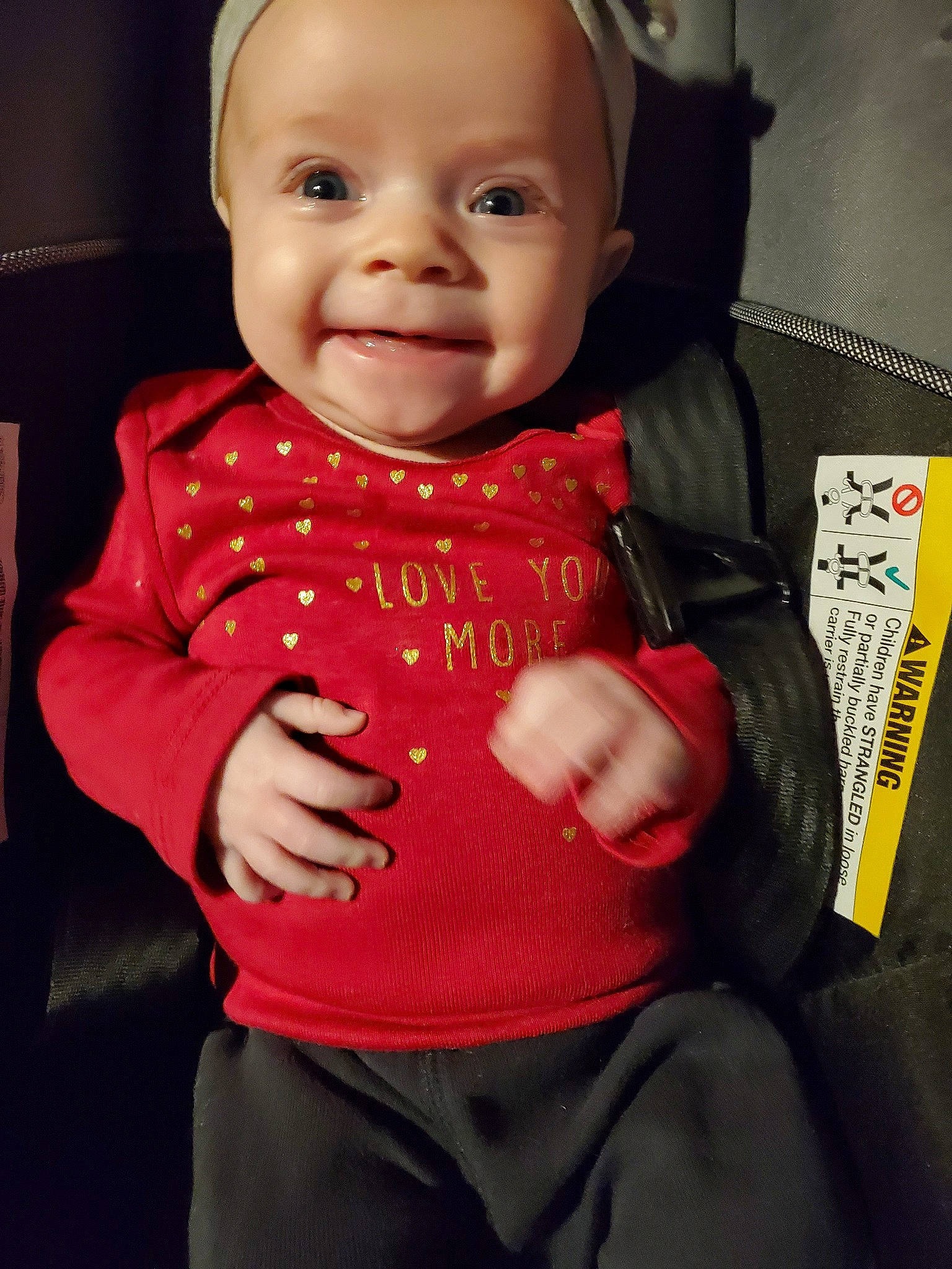 Haevyn is registered to the contest to win money with this photo: baby, baby_carriage, baby_products, cheek, child, eye, face, facial_expression, forehead, head, lip, nose, outerwear, person, pink, product, red, skin, sleeve, smile