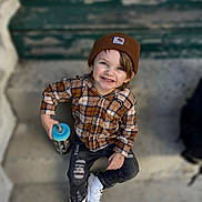 Bailey joined the competition — help win amazing prizes! child, boy, smiling, beanie, plaid_shirt, sippy_cup, steps, concrete, casual_clothing, white_sneakers, ripped_jeans, outdoor, portrait, happy, young, person, seated, blue_lid, brown_hat, cute