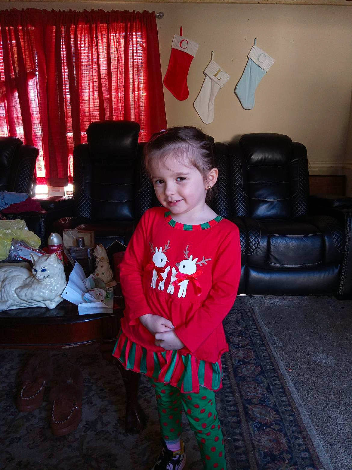 Lillian is registered to the contest to win money with this photo: carmine, chair, child, comfort, couch, curtain, event, flash_photography, flooring, fun, happy, holiday, joy, living_room, magenta, person, room, sitting, sleeve, tints_and_shades