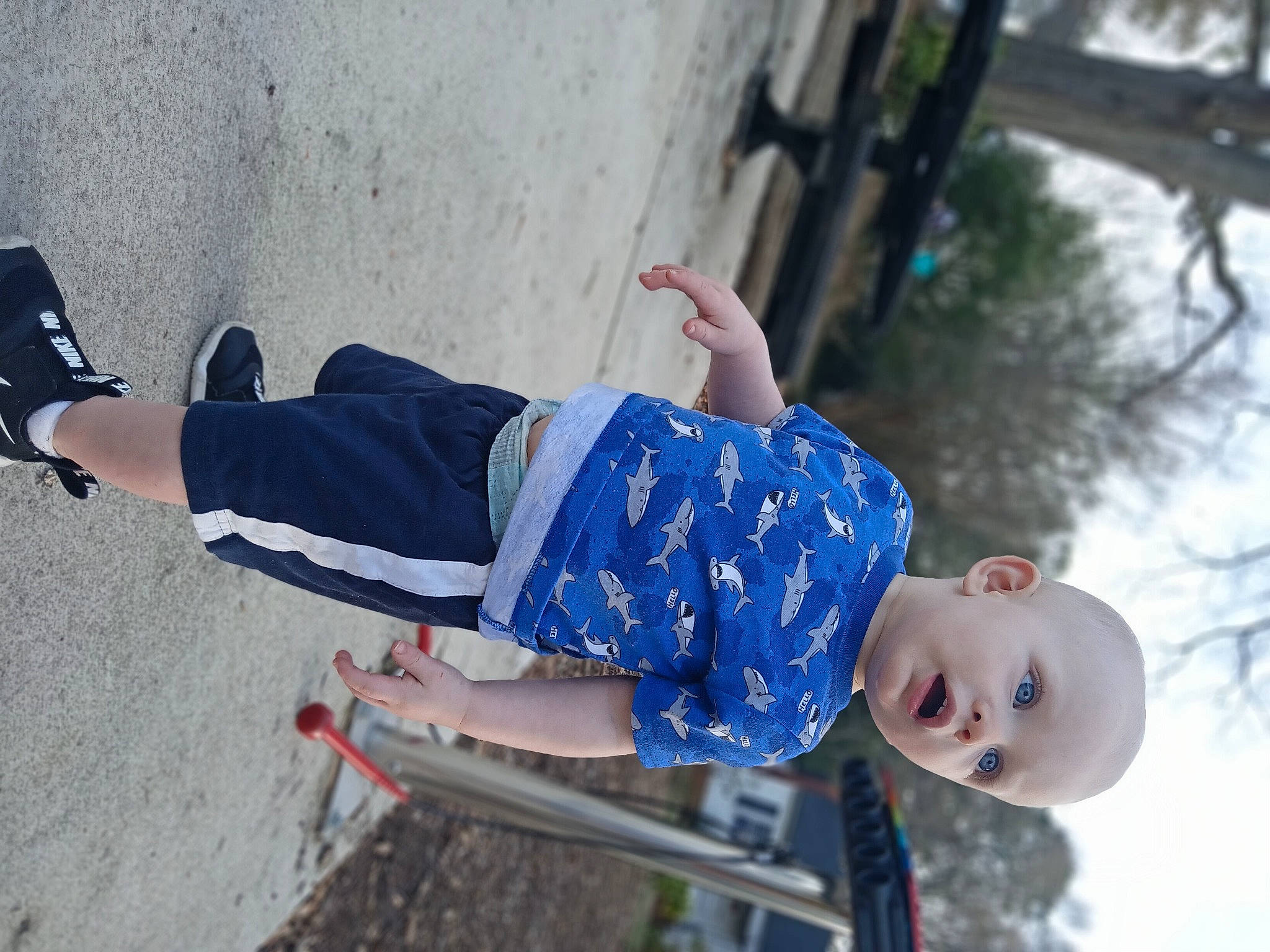 Asher is registered to the contest to win money with this photo: child, city, concrete, denim, elbow, electric_blue, fun, happy, human_leg, leisure, person, play, recreation, sky, sleeve, smile, surprise, toddler, tree