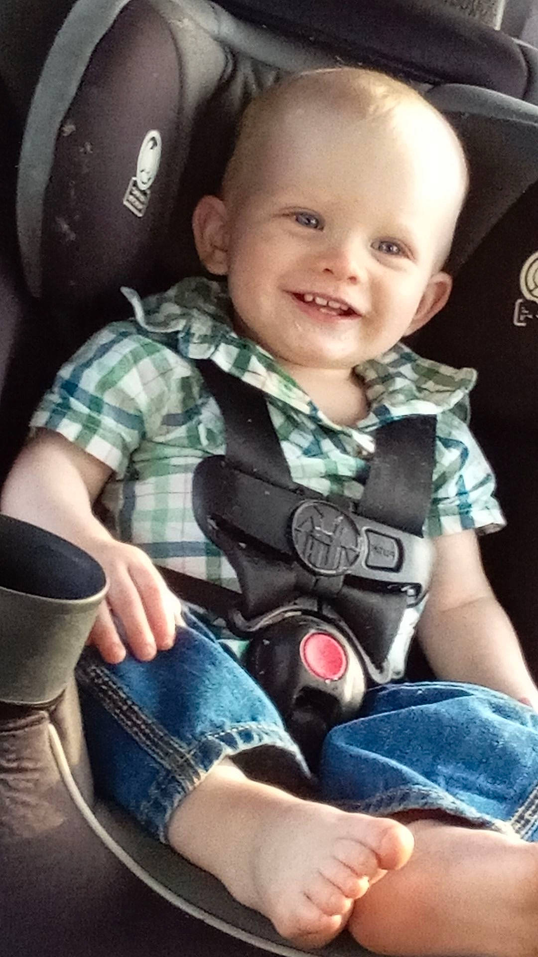 Asher is registered to the contest to win money with this photo: auto_part, baby, baby_toddler_clothing, child, comfort, cool, denim, face, finger, flash_photography, happy, joy, pattern, person, plaid, sitting, skin, sleeve, smile, thigh