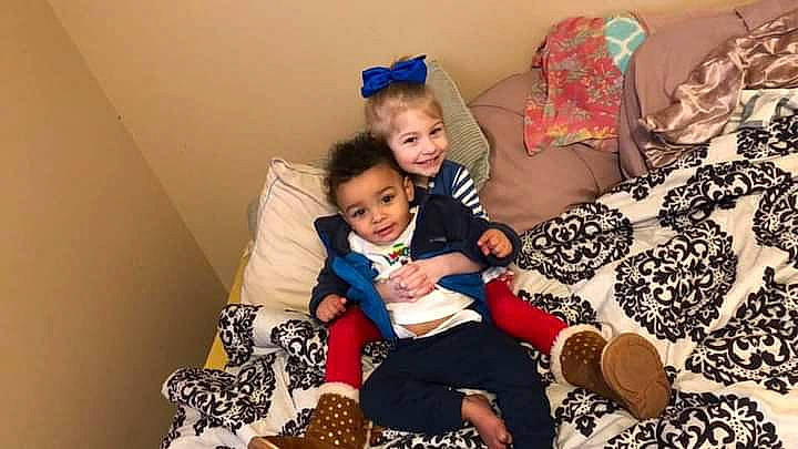 Annalynn is registered to the contest to win money with this photo: baby, baby_toddler_clothing, child, comfort, event, fun, happy, holiday, joy, lap, linens, party, pattern, person, play, playing_with_kids, room, sitting, smile, t_shirt