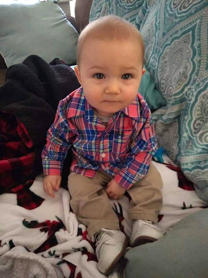Joseph is registered to the contest to win money with this photo: baby, baby_toddler_clothing, carmine, child, comfort, couch, lap, linens, living_room, pattern, person, plaid, room, sitting, sleeve, smile, tartan, textile, throw_pillow, toddler