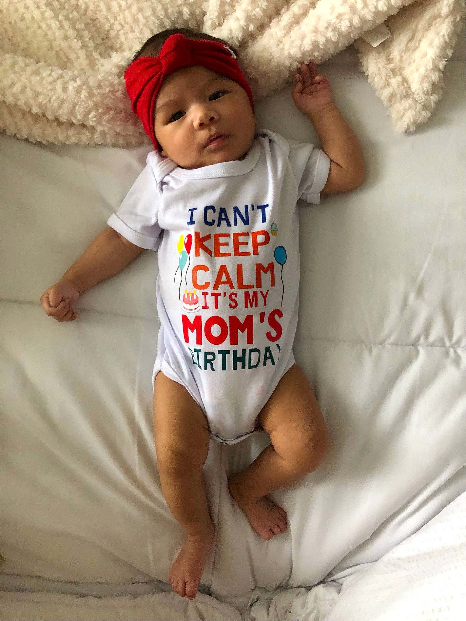 Elianna is registered to the contest to win money with this photo: baby, baby_safety, baby_sleeping, baby_toddler_clothing, cap, comfort, elbow, face, finger, happy, headwear, human_body, infant_bodysuit, leg, linens, person, skin, sleeve, textile, thigh