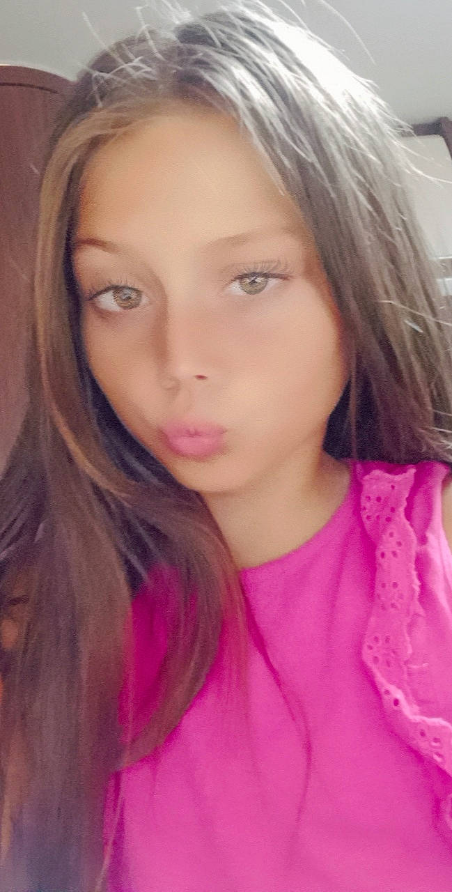 Stella participe au concours pour gagner de l'argent avec cette photo : black_hair, cheek, chin, eyebrow, eyelash, face, forehead, hair, iris, jaw, layered_hair, lip, long_hair, magenta, neck, nose, person, pink, skin, sleeve