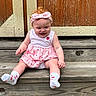 baby, child, pink_dress, headband, socks, wooden_steps, smiling, outdoor, happy, girl, portrait, cute, infant, sitting, strawberry_pattern, wood, natural_light, casual, summer, fashion