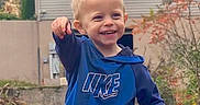 Hudson is registered to the contest to win money with this photo: blond_hair, blue_clothing, boy, casual, child, daylight, face, garden, happy, hoodie, house, outdoor, photography, plants, pointing, portrait, smiling, standing, teeth, toddler