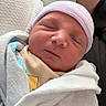 Zion is registered to the contest to win money with this photo: newborn, baby, swaddled, blanket, hat, sleeping, infant, hospital, tattoo, arm, person, closeup, cute, portrait, resting, soft, skin, peaceful, wrapped, cozy