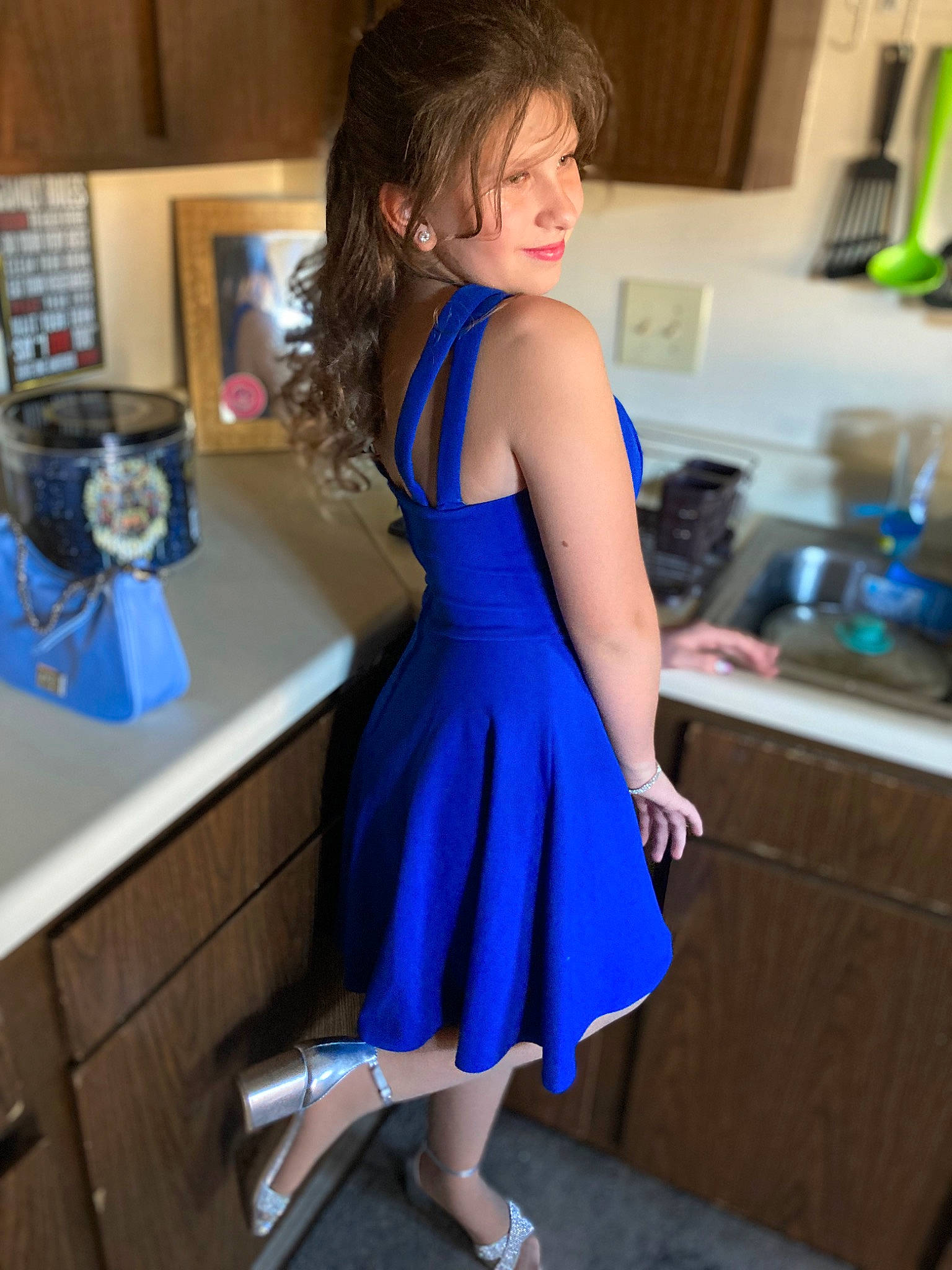 Mia is registered to the contest to win money with this photo: cooking, countertop, day_dress, dress, electric_blue, fashion_design, formal_wear, hair, homemaker, human_leg, joint, kitchen, kitchen_appliance, leg, long_hair, one_piece_garment, person, room, smile, thigh