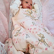 Amara joined the competition — help win amazing prizes! newborn, baby, infant, blanket, pink, clothing, pattern, deer, floral, cute, sleeping_bag, portrait, soft, cozy, indoors, child, face, hand, lying, cute_outfit