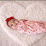 Cambree is registered to the contest to win money with this photo: baby, infant, heart_shaped_rug, pink_outfit, red_hearts, headband, red_bow, cute, cozy, soft_texture, sleepwear, portrait, lying_down, smiling, child, adorable, fluffy, indoor, toddler, baby_girl