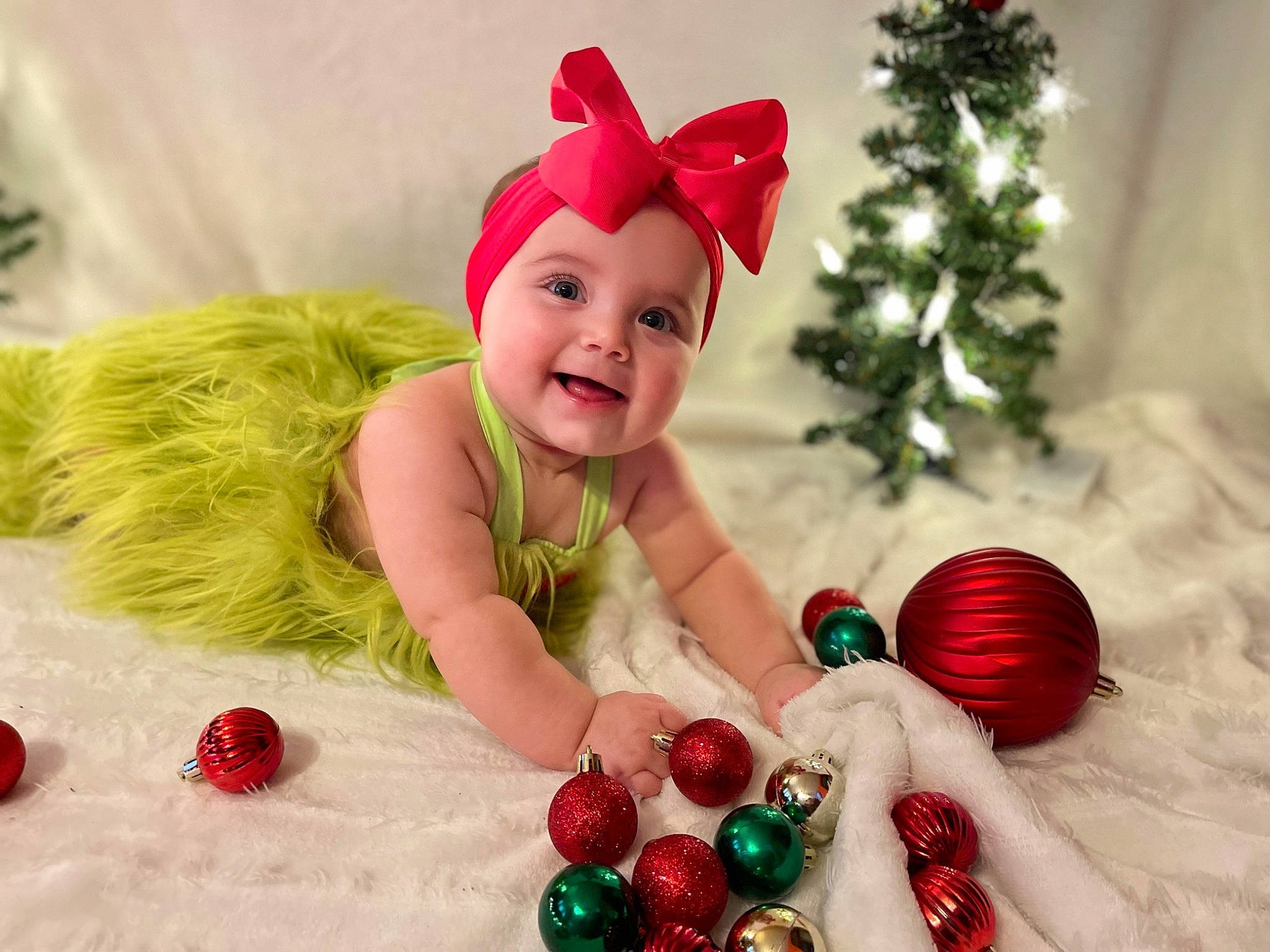 Adaleigh is registered to the contest to win money with this photo: baby, baby_toddler_clothing, christmas, christmas_decoration, christmas_eve, christmas_ornament, christmas_tree, costume_hat, event, fun, happy, hat, headwear, holiday, holiday_ornament, joy, ornament, person, red, santa_claus