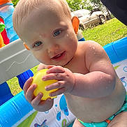 Rorik is registered to the contest to win money with this photo: baby, car, clothing, diaper, face, grass, head, nature, outdoors, person, photography, plant, pool, portrait, summer, swimwear, transportation, vehicle, water, yard