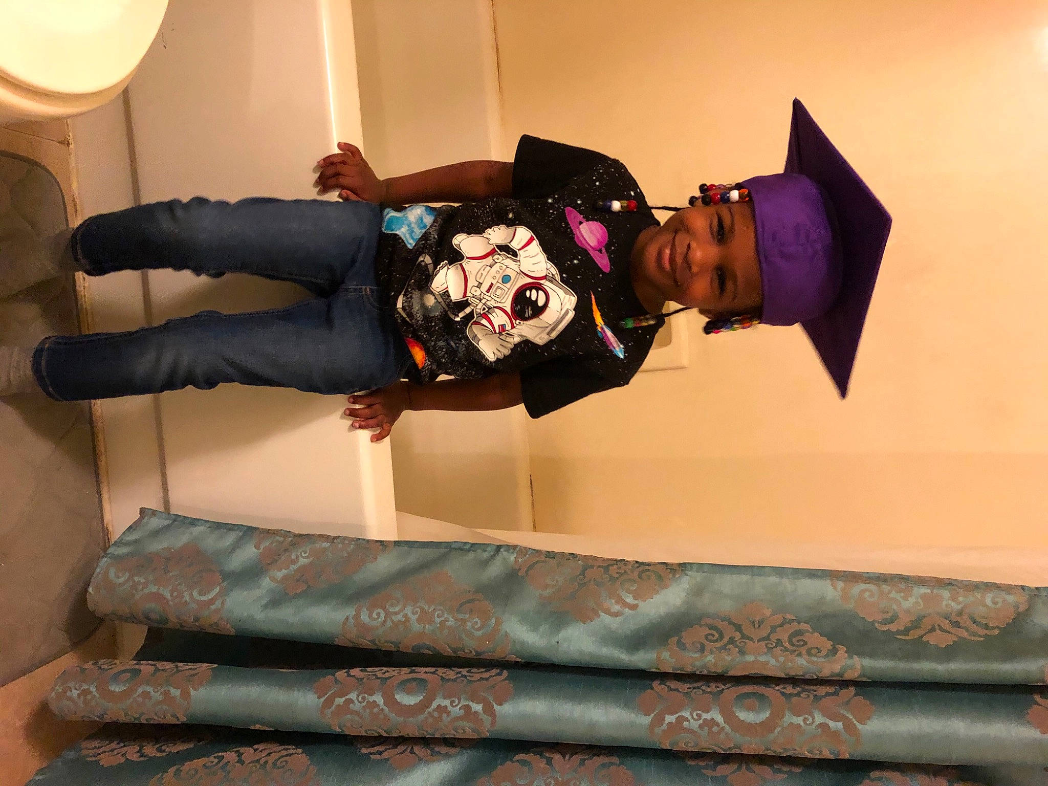 Makenzi is registered to the contest to win money with this photo: comfort, costume, dress, event, flooring, fun, hat, headwear, human_leg, joy, knee, linens, person, room, sitting, sleeve, smile, textile, thigh, tree