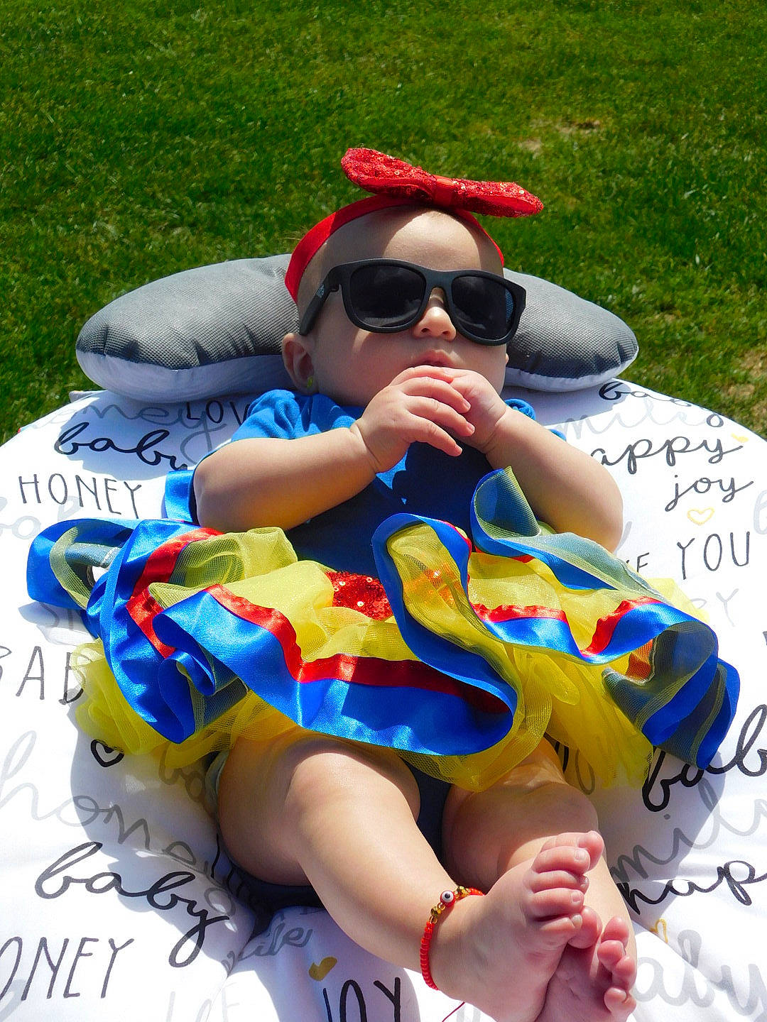 Amelia joined the competition — help win amazing prizes! baseball_cap, eyewear, finger, foot, fun, goggles, grass, human_leg, knee, lap, leisure, person, photograph, recreation, red, shorts, sunglasses, thigh, vision_care, white