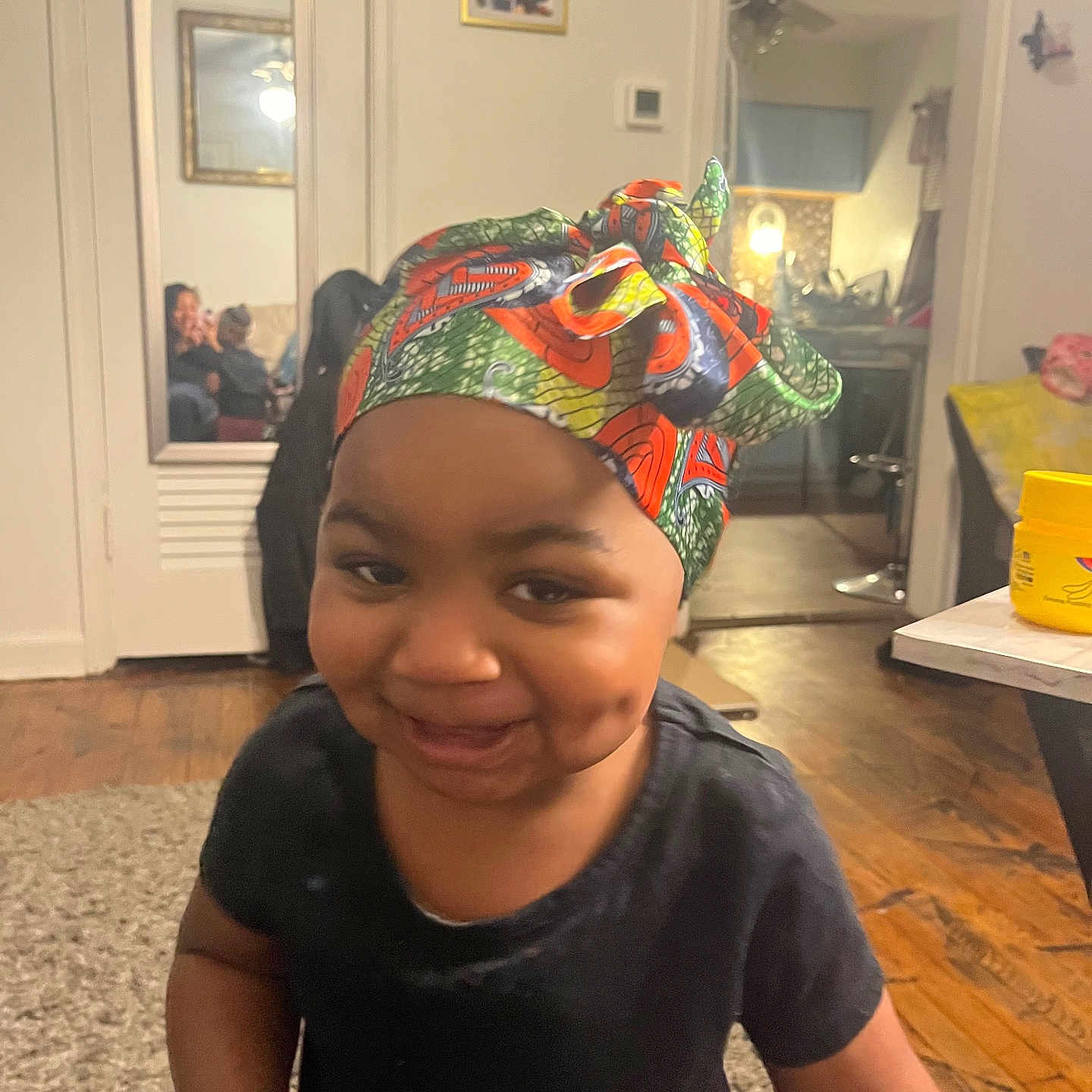 Miair joined the competition — help win amazing prizes! toddler, child, smile, headwrap, indoor, living_room, mirror, reflection, carpet, wooden_floor, table, container, people, family, happy, person, furniture, home, casual, portrait