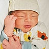 baby, child, closed_eyes, closeup, cozy, cute, hands, hat, indoors, infant, newborn, onesie, patterned_clothing, peaceful, portrait, rest, skin, sleeping, soft, warm