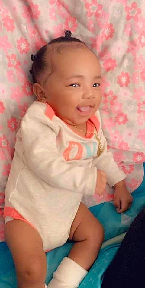 Melani is registered to the contest to win money with this photo: baby, baby_products, baby_toddler_clothing, cheek, child, finger, lip, nose, person, pink, product, sitting, skin, smile, toddler