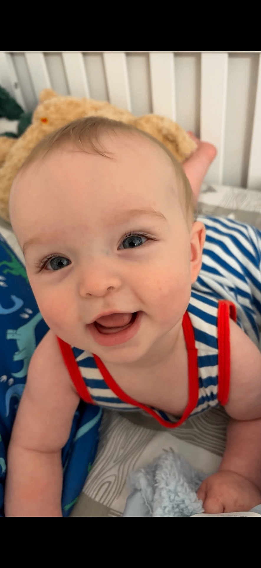 Jericho joined the competition — help win amazing prizes! baby, child, smiling, blue_eyes, striped_clothing, crawling, bed, blanket, plush_toy, happy, close_up, infant, person, cute, indoors, soft_lighting, face, portrait, skin, young_child