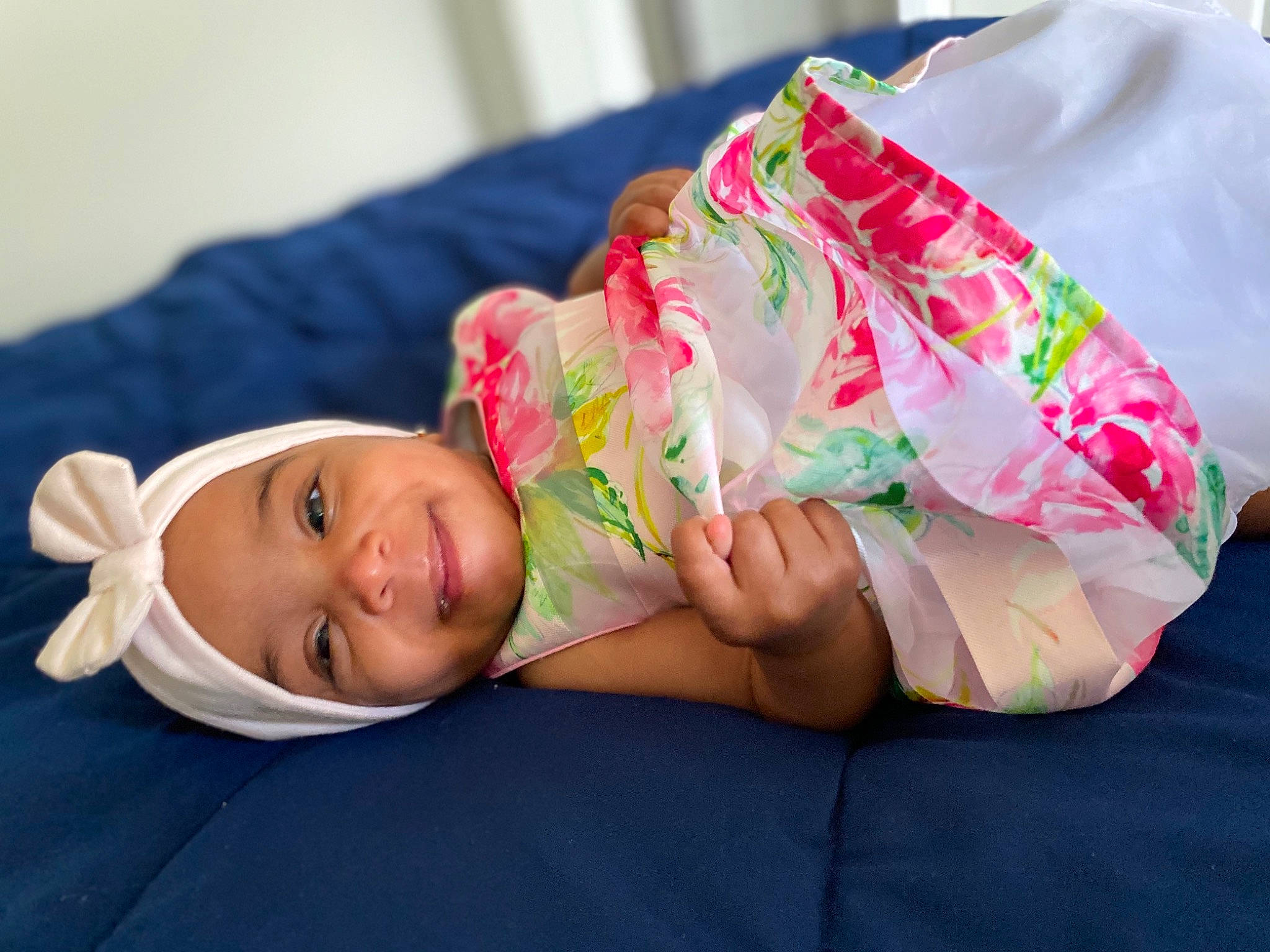 Aila is registered to the contest to win money with this photo: abdomen, baby, child, comfort, elbow, fashion_accessory, fun, grass, happy, hat, headwear, human_leg, joy, leisure, magenta, person, portrait_photography, sitting, smile, textile