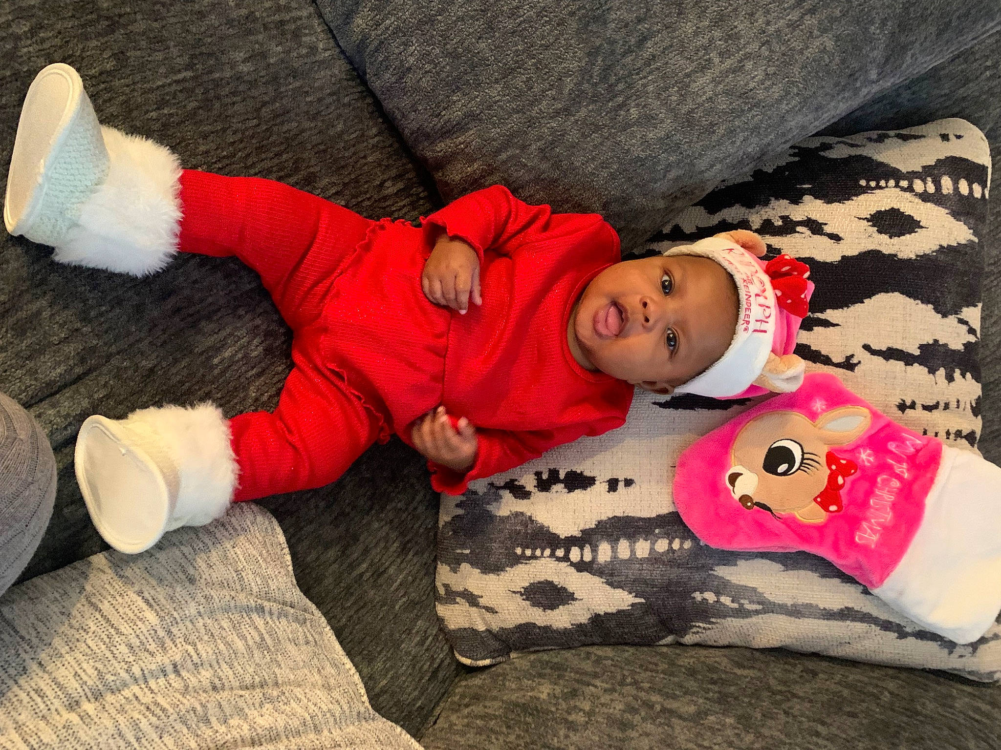 Azaria is registered to the contest to win money with this photo: baby, baby_sleeping, baby_toddler_clothing, carmine, child, comfort, happy, hat, head, headwear, human_leg, lap, linens, pattern, person, sleeve, sock, textile, thigh, toddler