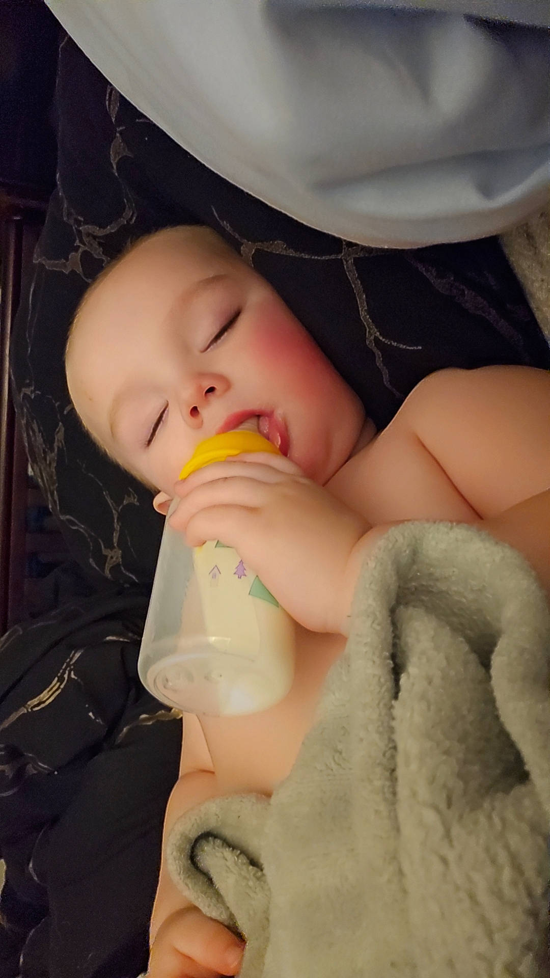 Lucas is registered to the contest to win money with this photo: baby, baby_bottle, cheek, chin, comfort, drinkware, eye, eyebrow, eyelash, finger, gesture, head, human_body, lip, mouth, neck, nose, person, plastic_bottle, skin