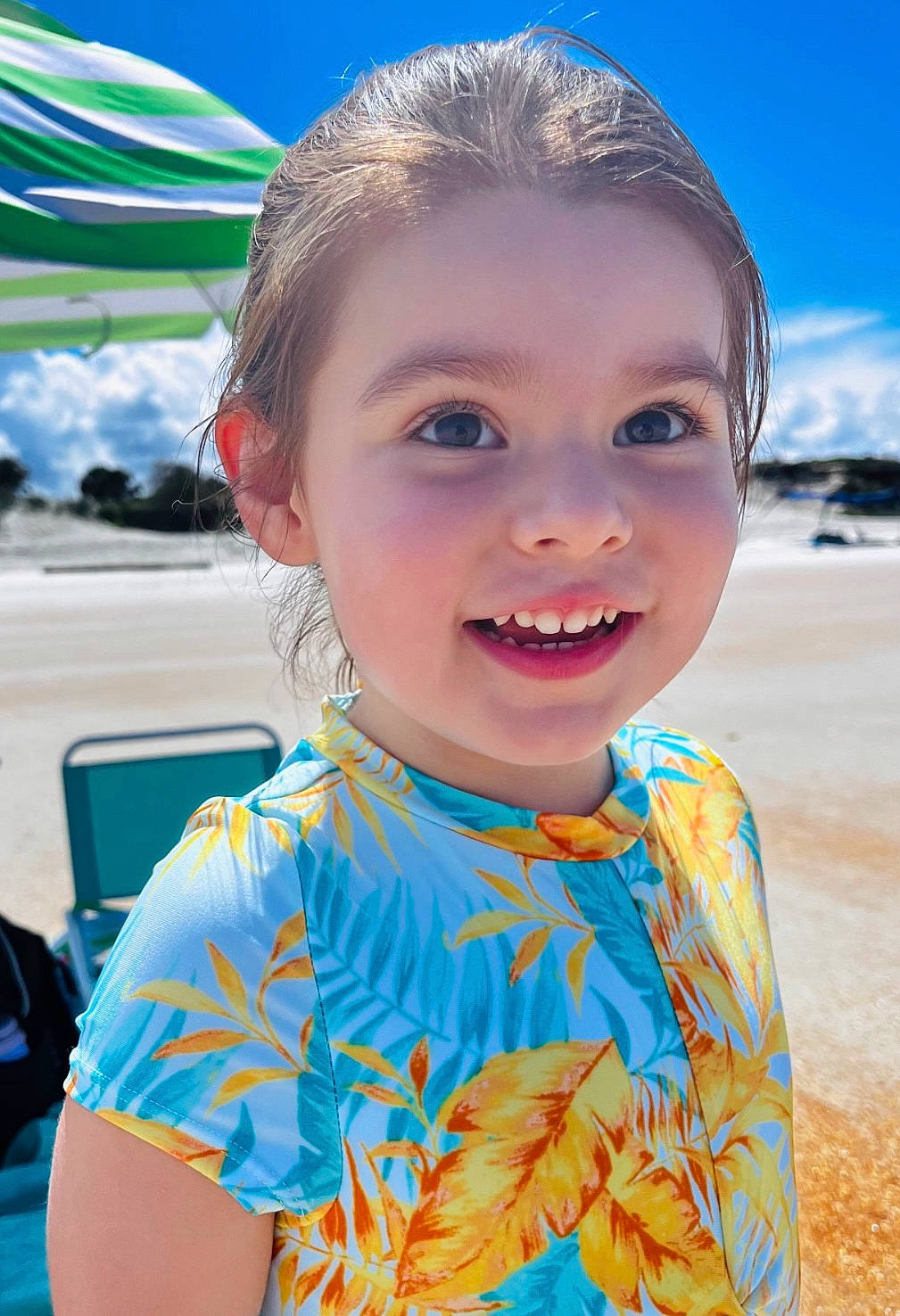 Norah is registered to the contest to win money with this photo: azure, beach, blue, child, cloud, electric_blue, event, fun, happy, iris, joy, leisure, person, recreation, skin, sky, smile, summer, t_shirt, toddler
