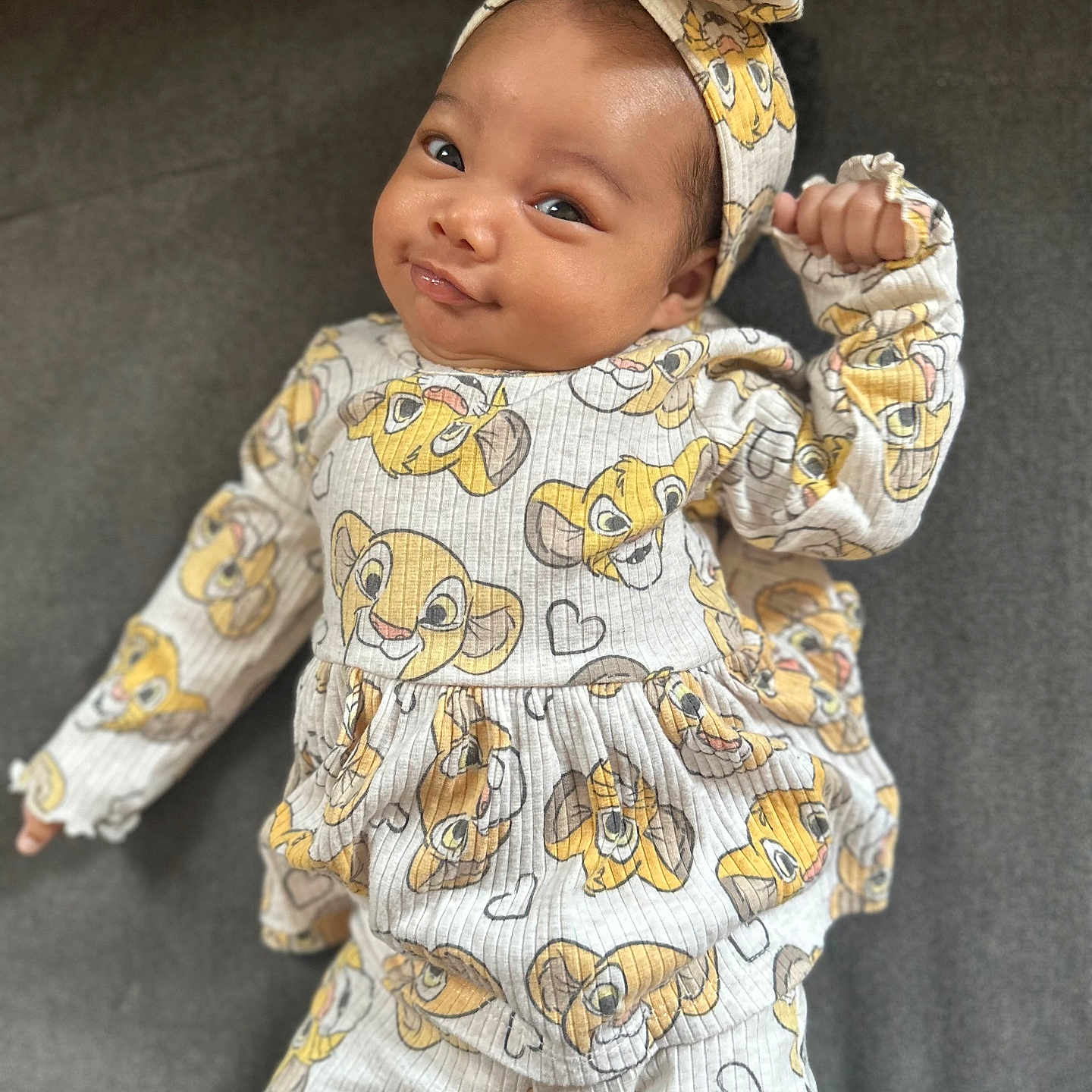 Emerald is registered to the contest to win money with this photo: baby, bonnet, clothing, dress, face, formalwear, happy, hat, head, longsleeve, newborn, pajamas, pants, person, photography, portrait, sitting, sleeve, smile, suit