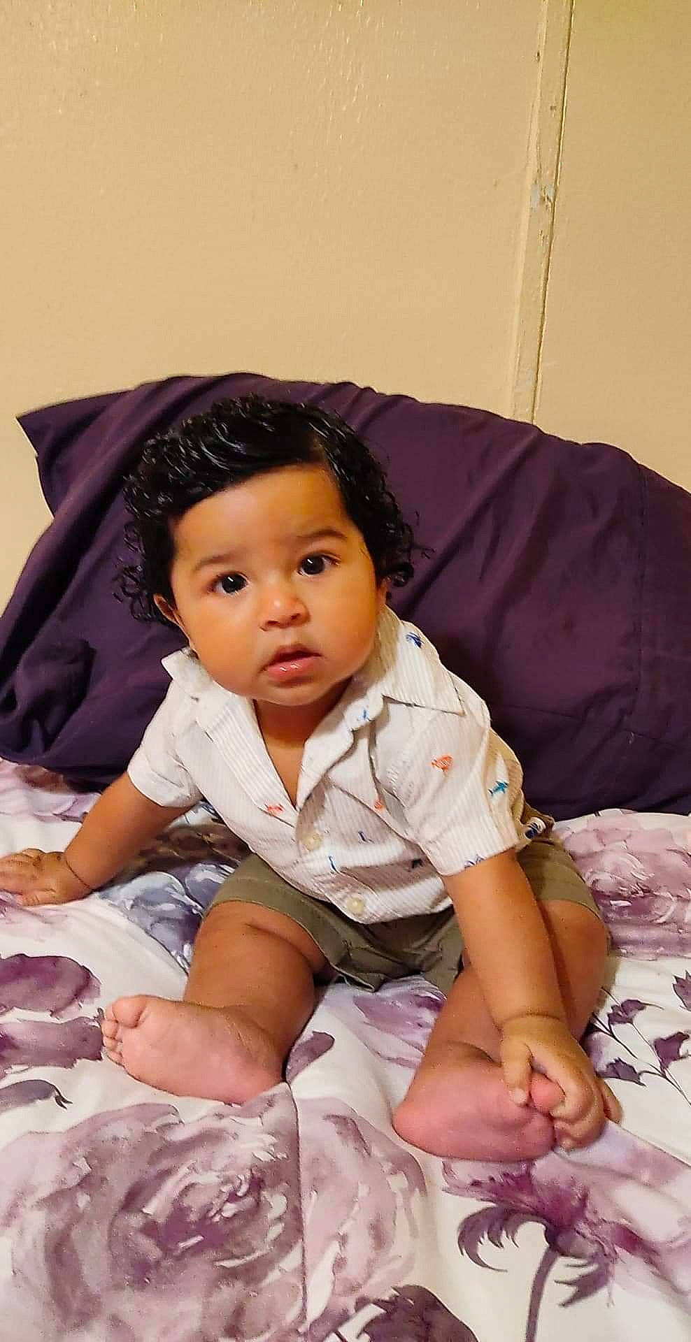 Dylan is registered to the contest to win money with this photo: baby, black_hair, cheek, child, eye, person, pink, sitting, skin, smile, toddler