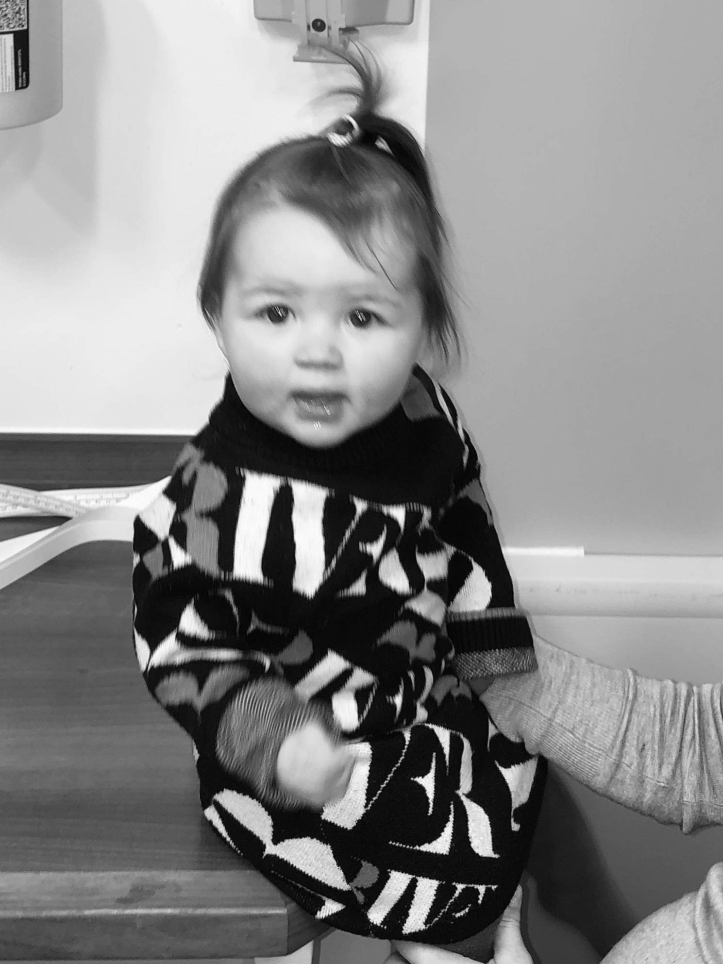 Bella is registered to the contest to win money with this photo: baby, baby_toddler_clothing, black, black_and_white, child, monochrome, monochrome_photography, neck, outerwear, person, photography, room, sitting, sleeve, smile, style, toddler, white