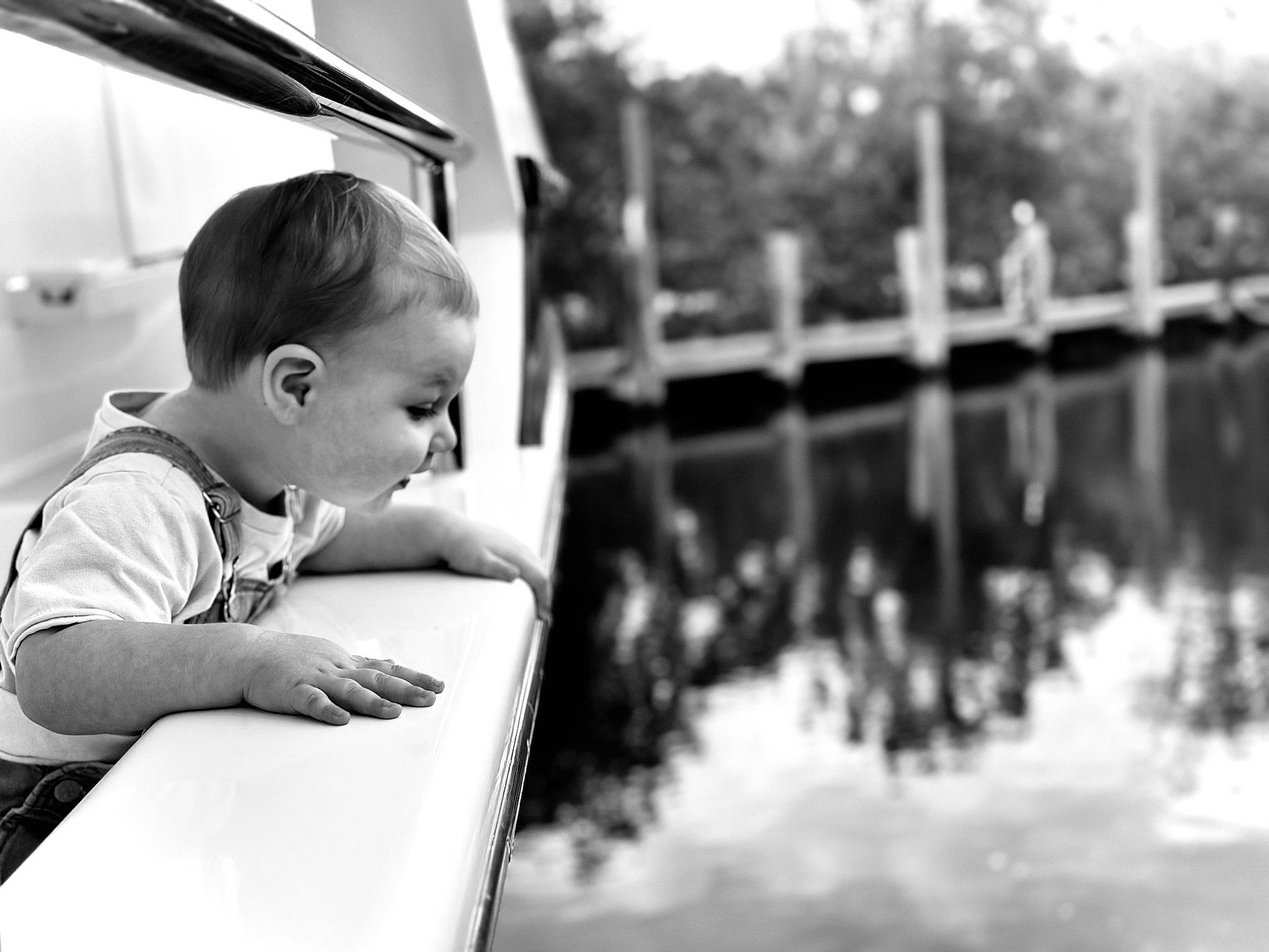 Beckham is registered to the contest to win money with this photo: baby, black, black_and_white, child, flash_photography, fun, hair, happy, head, lake, leisure, monochrome, monochrome_photography, person, smile, snapshot, style, toddler, tree, water