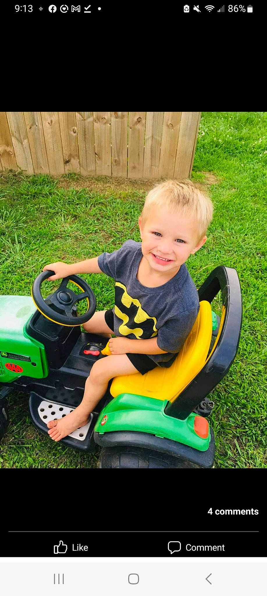 Noah is registered to the contest to win money with this photo: automotive_design, automotive_tire, child, fun, grass, happy, joy, lawn, leisure, motor_vehicle, person, plant, recreation, riding_toy, shorts, smile, t_shirt, tire, toddler, toy