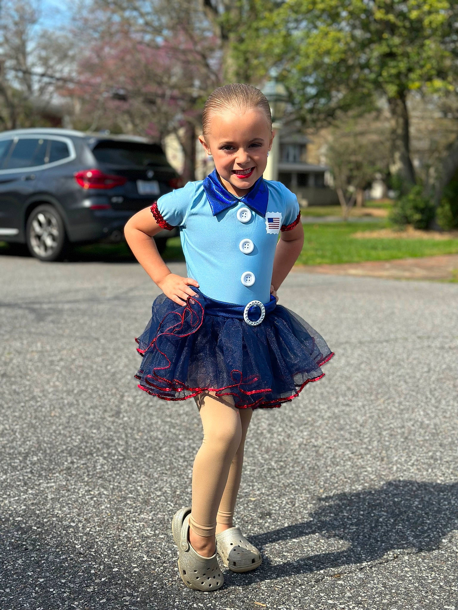 Kepleigh is registered to the contest to win money with this photo: asphalt, car, day_dress, denim, dress, electric_blue, face, joy, knee, person, plaid, plant, road, sleeve, smile, summer, tartan, tire, toddler, tree
