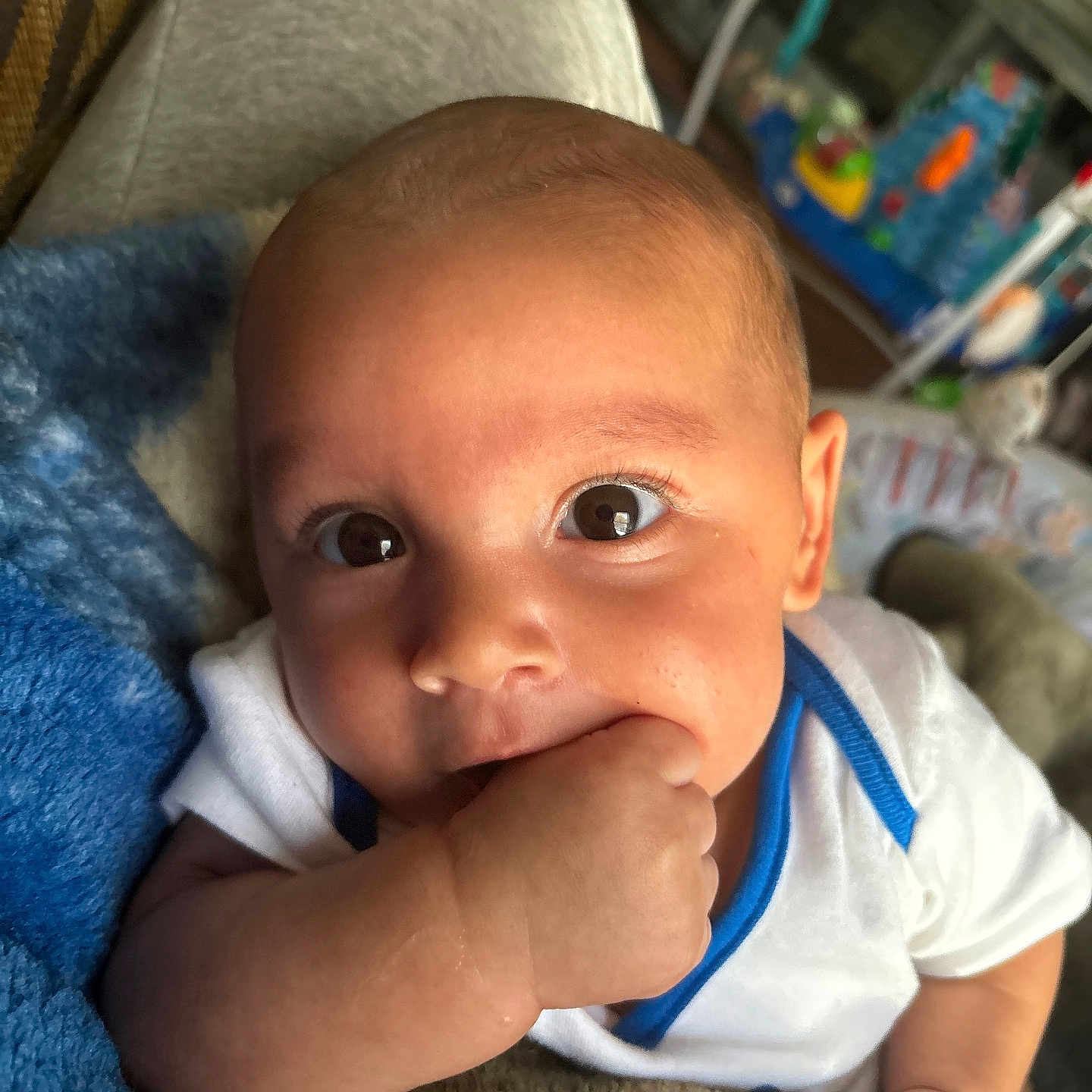 Paxton is registered to the contest to win money with this photo: baby, bodypart, clothing, couch, cushion, face, finger, furniture, hand, happy, head, homedecor, indoors, newborn, person, photography, portrait, quilt, smile, t_shirt