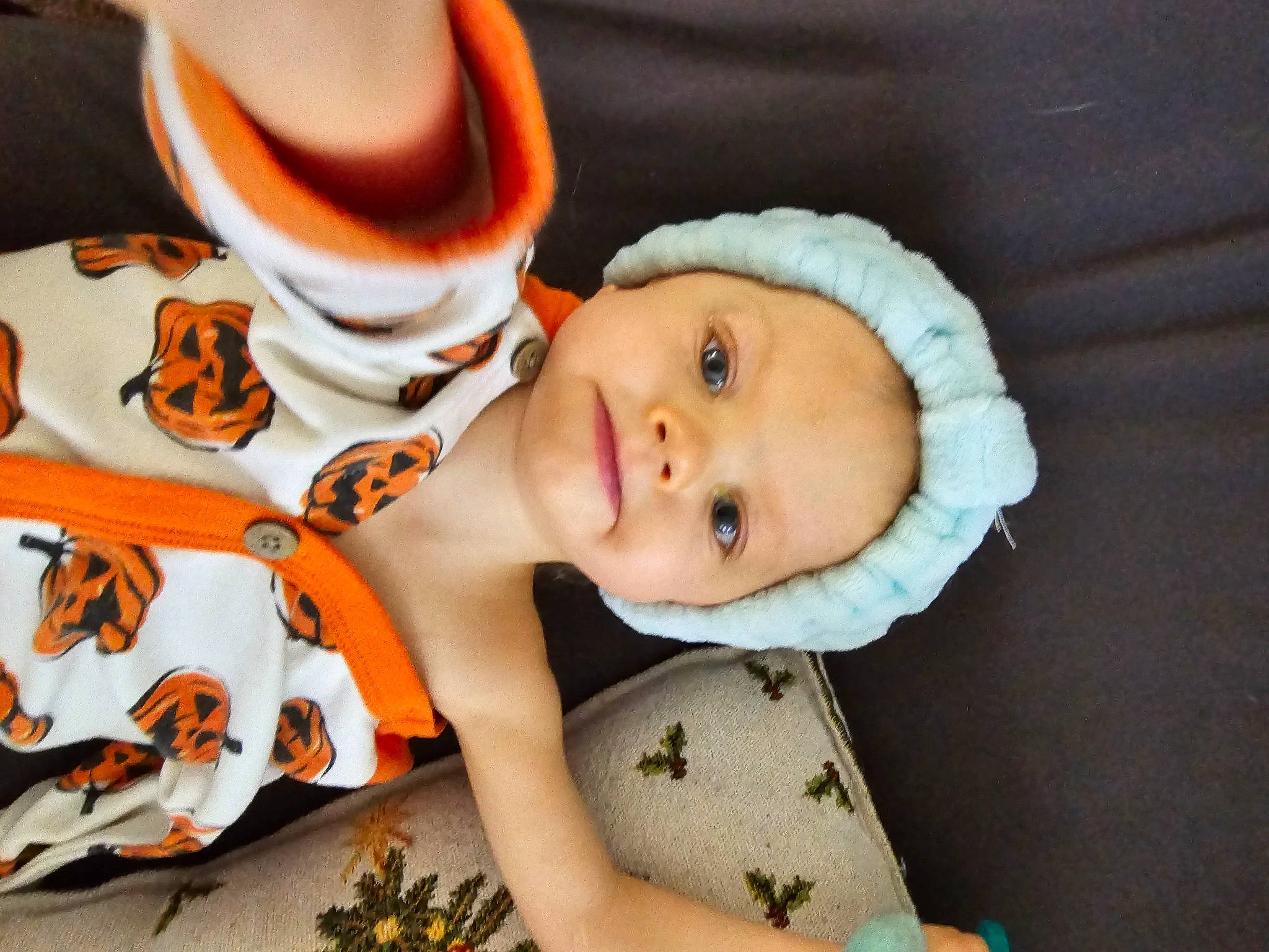 Riley joined the competition — help win amazing prizes! baby, baby_products, baby_toddler_clothing, cheek, child, cup, dress, drinkware, fun, happy, hat, headgear, headwear, mouth, orange, pattern, person, portrait_photography, sitting, smile