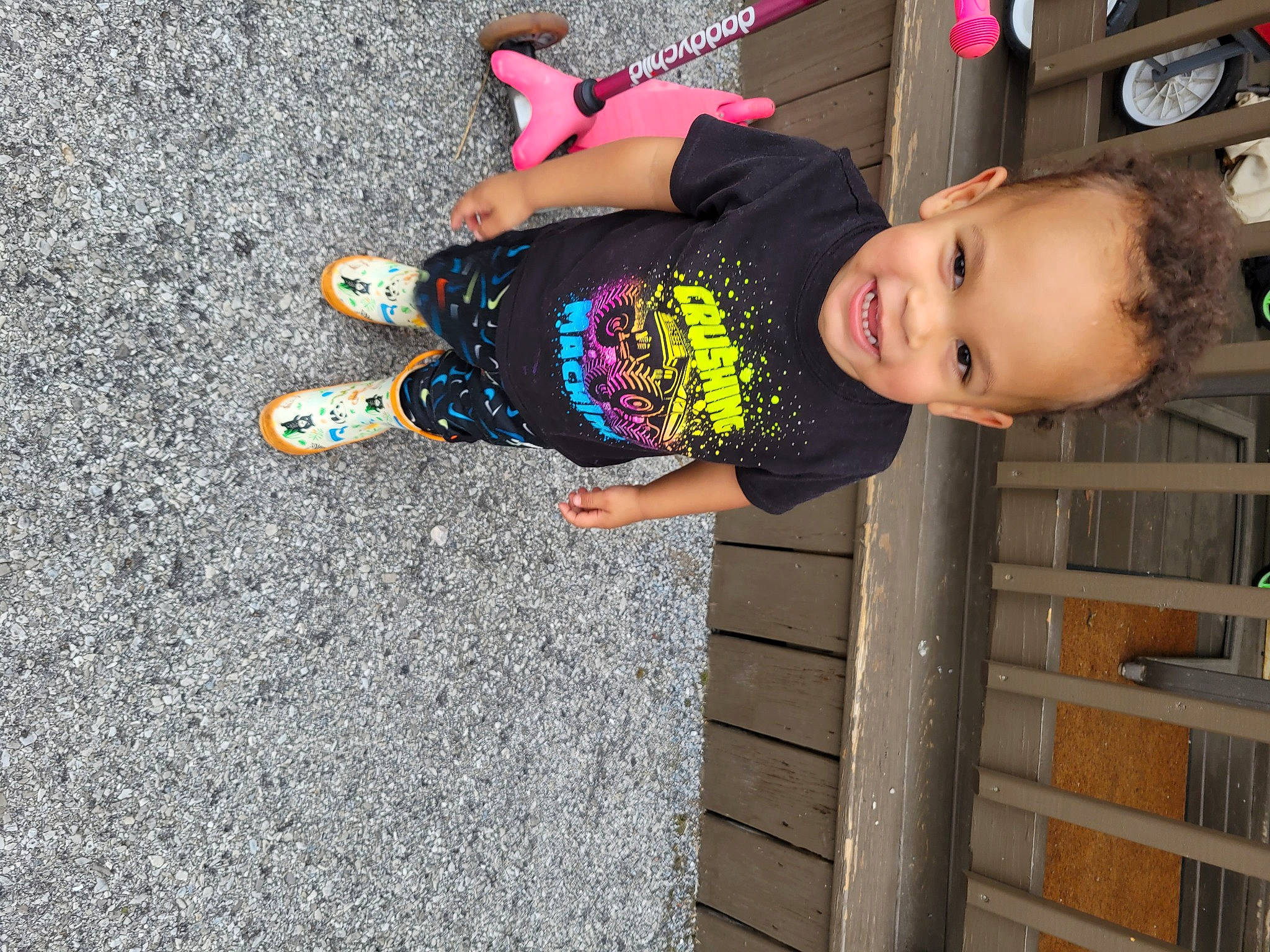 Lincoln is registered to the contest to win money with this photo: asphalt, baby_toddler_clothing, child, concrete, electric_blue, fun, happy, human_leg, joy, pattern, person, road_surface, shadow, sidewalk, smile, t_shirt, tar, thigh, toddler, vacation