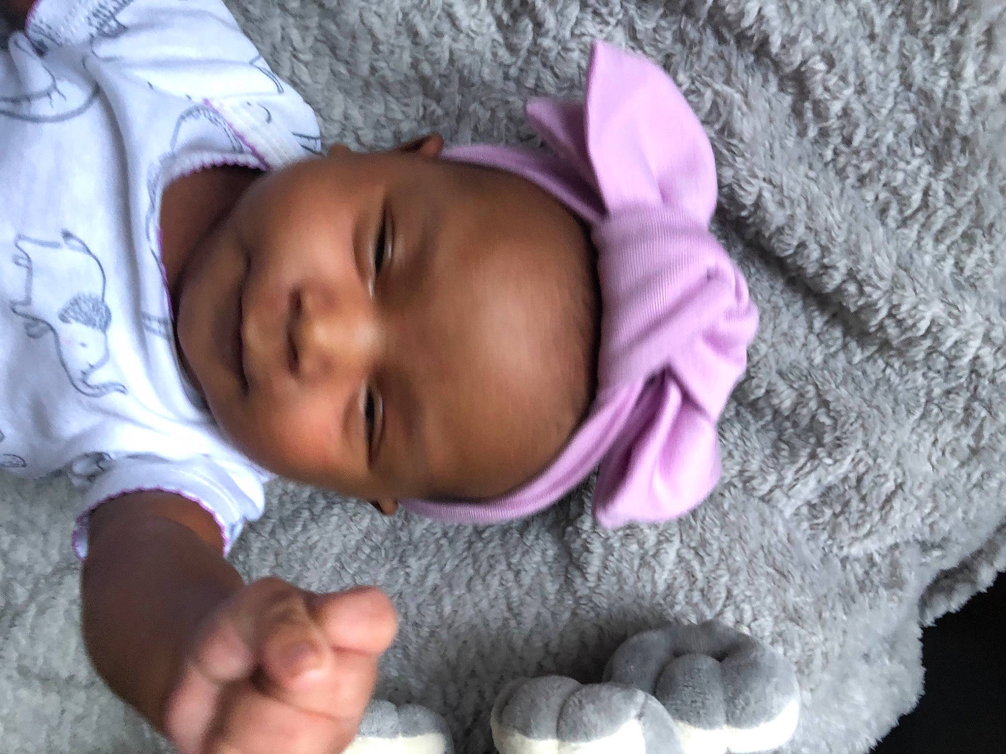 Mahriannah is registered to the contest to win money with this photo: arm, baby, baby_toddler_clothing, cheek, chin, comfort, face, finger, gesture, hand, human, lip, mouth, nose, organ, person, pink, purple, skin, smile