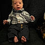 Parker is registered to the contest to win money with this photo: baby, infant, newborn, bow_tie, plaid_shirt, button_down, pants, bare_feet, toes, surprised_expression, sitting, portrait, couch, dark_background, small_hands, cute, casual_clothing, wooden_buttons, soft_lighting, stuffed_toy