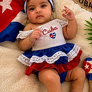 Emma joined the competition — help win amazing prizes! baby, child, cuba, flag, hat, maraca, red_shoes, dress, headband, blanket, cute, infant, portrait, smiling, cultural, indoor, colorful, soft_texture, decor, celebration