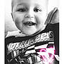 baby, bodypart, clothing, face, finger, hand, happy, head, laughing, light, lighting, machine, mouth, person, photography, portrait, smile, t_shirt, teeth, wheel