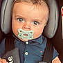 baby, pacifier, car_seat, child, blue_polo, harness, joie_brand, infant, seatbelt, straps, cute, portrait, young_child, sitting, looking_at_camera, indoors, close_up, face, head_support, small_hand