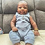 Kairo is registered to the contest to win money with this photo: baby, infant, child, onesie, blue_clothing, bracelet, couch, furniture, smile, face, portrait, sitting, indoors, cute, young_child, relaxing, soft_texture, home, comfortable, person