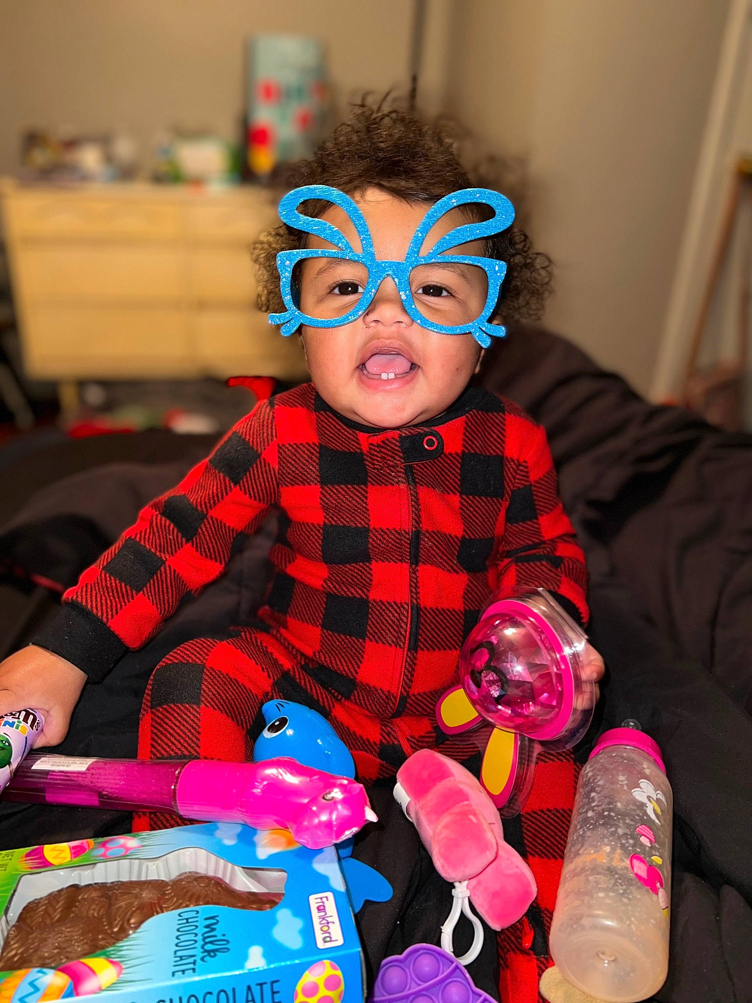 Shylo is registered to the contest to win money with this photo: baby, baby_toddler_clothing, blue, child, eye, eyewear, glasses, head, magenta, party_supply, person, pink, plaid, product, purple, red, sunglasses, textile, toddler, toy