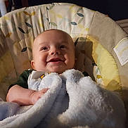 Tobias joined the competition — help win amazing prizes! baby, blanket, smiling, infant, face, baby_seat, cozy, happy, child, indoor, soft, cute, portrait, clothing, comfort, toddler, expression, warm, young, resting