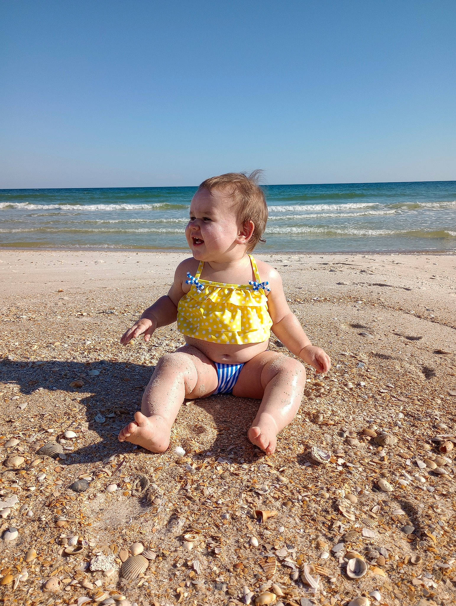 Elora joined the competition — help win amazing prizes! barefoot, beach, child, coastal_and_oceanic_landforms, foot, fun, happy, horizon, landscape, leisure, mammal, people_in_nature, people_on_beach, person, sand, sky, smile, toddler, vertebrate, water