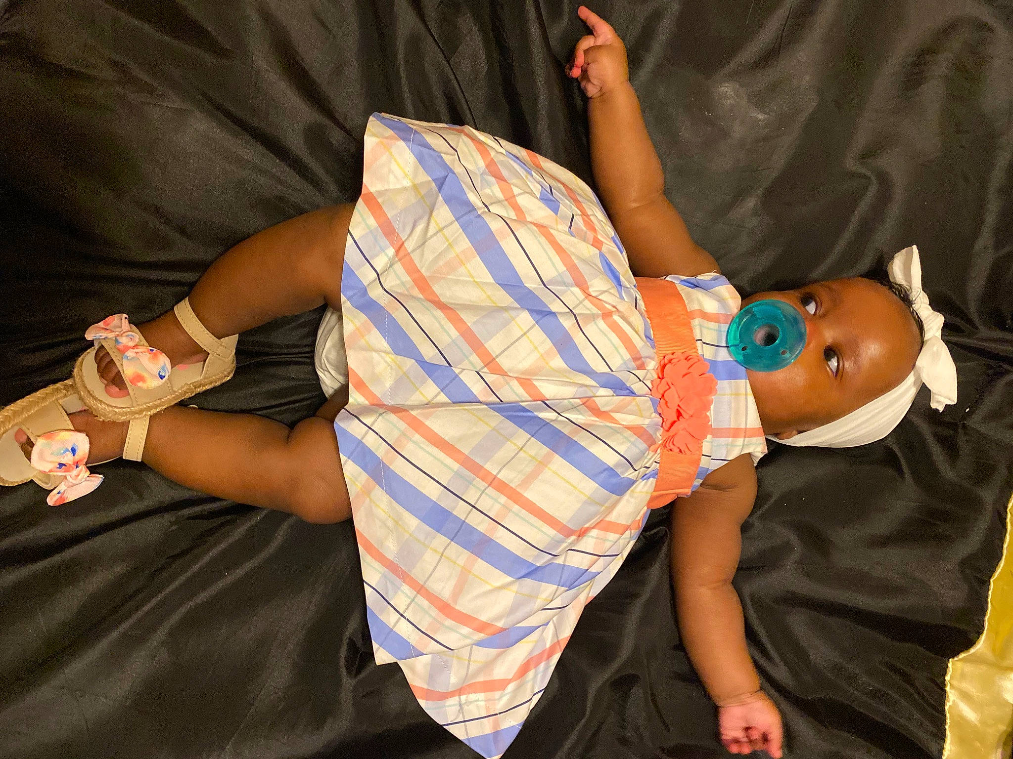 Angelina is registered to the contest to win money with this photo: baby_toddler_clothing, comfort, cool, dress, elbow, facial_expression, finger, fun, hat, human_leg, interaction, joint, leg, nail, person, product, sunglasses, textile, thigh, toddler