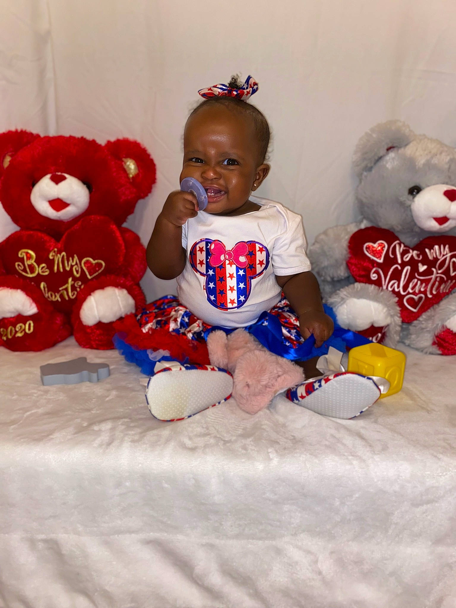Angelina is registered to the contest to win money with this photo: baby_toddler_clothing, baby_toys, carmine, child, fun, fur, happy, mammal, person, pink, plush, red, room, stuffed_toy, sunglasses, t_shirt, teddy_bear, textile, toddler, toy